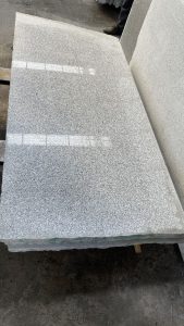 Rough granite slab on the saw, sawn face up