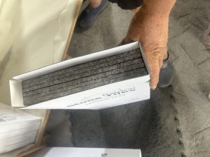 Granite thin tiles foam-lined inside a wooden crate